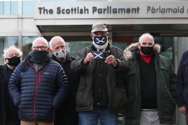 Former miners outside the Scottish Parliament waiting for the decision