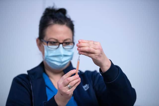 Nurse Sarah MacLeod prepares a vaccine at the mass vaccine centre at the Edinburgh International Conference Centre on February 1, 2021. Photo by Jane Barlow/Getty Images