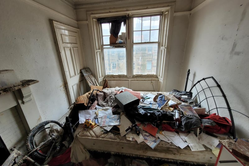 The bedroom is in a similar state to the rest of the flat, but experts say the property has a 'huge amount of potential'.