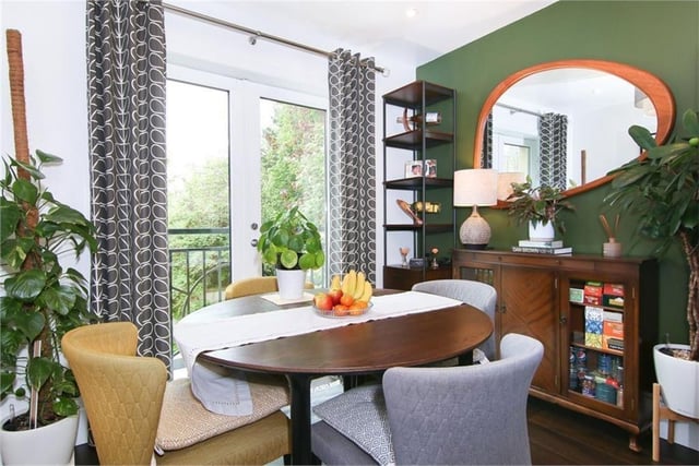 The dining area enjoys a position next to the patio doors and Juliet balcony, with a peaceful, leafy outlook.