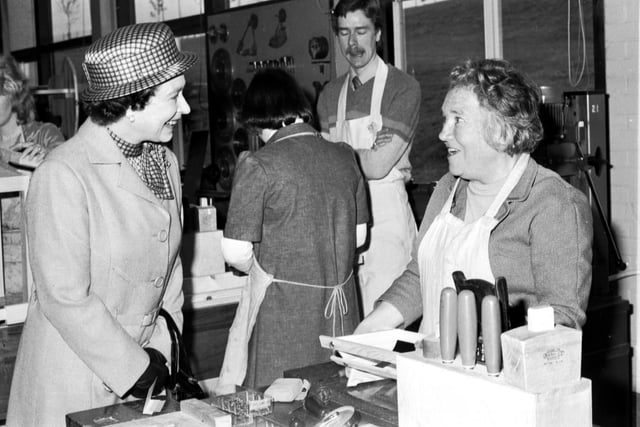 Queen Elizabeth II and Prince Philip Duke of Edinburgh (not in picture) visited the woodwork class at Wester Hailes Education Centre in Edinburgh, July 1980. The Queen is pictured chatting to a mature student.