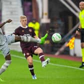 Istanbul's Bertrand Traore pokes the ball away from Hearts defender Alex Cochrane at Tynecastle.
