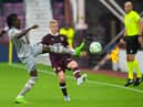 Istanbul's Bertrand Traore pokes the ball away from Hearts defender Alex Cochrane at Tynecastle.