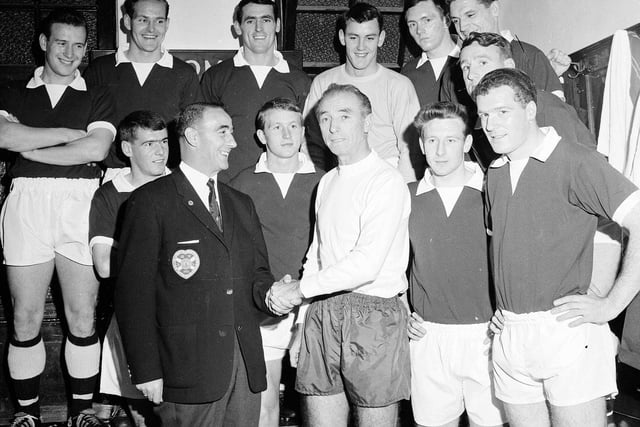 Stanley Matthews is pictured in the dressing room meeting the Hearts team and manager Tommy Walker after making his last appearance in Scotland with Stoke City in a friendly at Tynecastle on October 16, 1964.