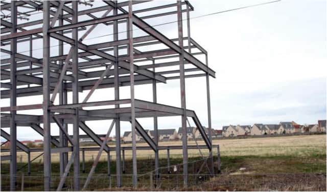 Development of the stadium stalled after a steel stand frame was put up.