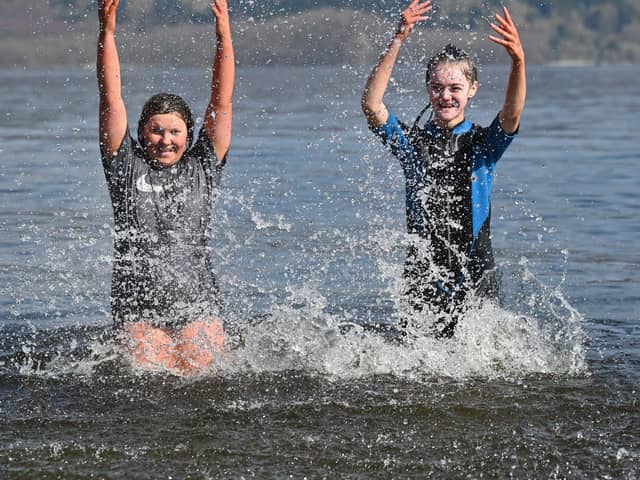Swimmers enjoying the sunshine at Luss on Loch Lomond on Saturday. Picture: John Devlin