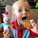 Member of the Rainbows enjoying baking cookies with her girl guide friends online.