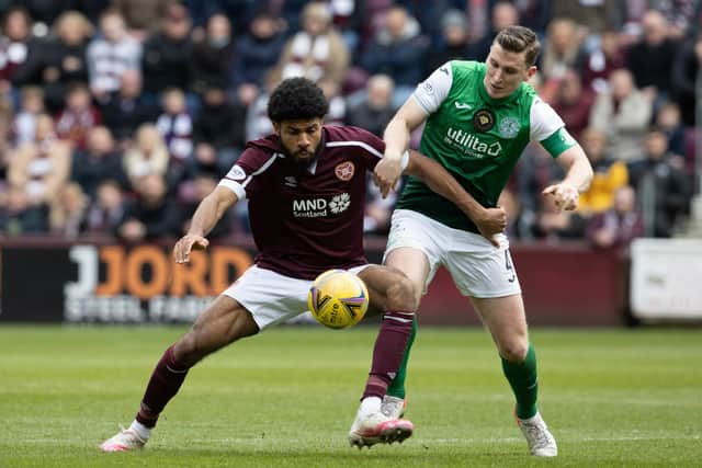 Ellis Simms and Paul Hanlon battle for possession during Hearts' victory over Hibs at Tynecastle on Saturday. Picture: SNS