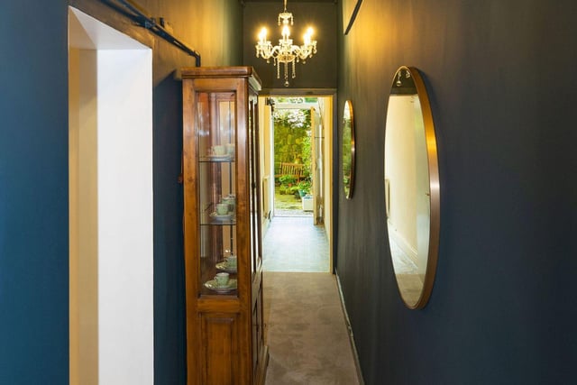 The flat's atmospheric hallway leads through to the garden and has a walk-in storage cupboard.