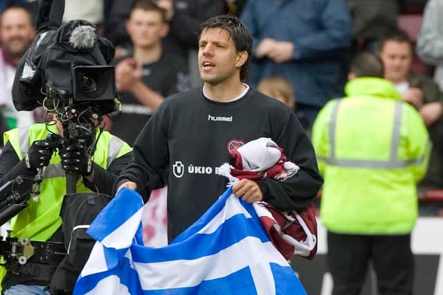Takis Fyssas shows off the Greek flag at Tynecastle