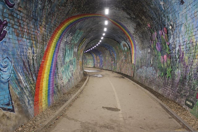 The old railway tunnel connecting Colinton Village to Craiglockhart Dell was transformed into a vibrant mural between 2018 and 2020, depicting the village’s history. Chris Rutterford led a team of more than 600 people to pain the 140-metre long tunnel and it is now Scotland’s largest heritage mural. Photo: Graeme-Yuill