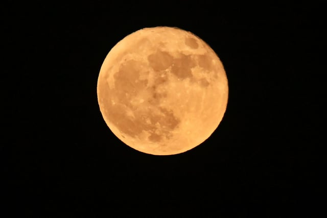 The full "Strawberry supermoon" rises over Los Angeles- The June full moon is named for the strawberry harvesting season of the Alongquin Native American tribe from the northeast United States and eastern Canada. (Photo by Frederic J. BROWN / AFP)