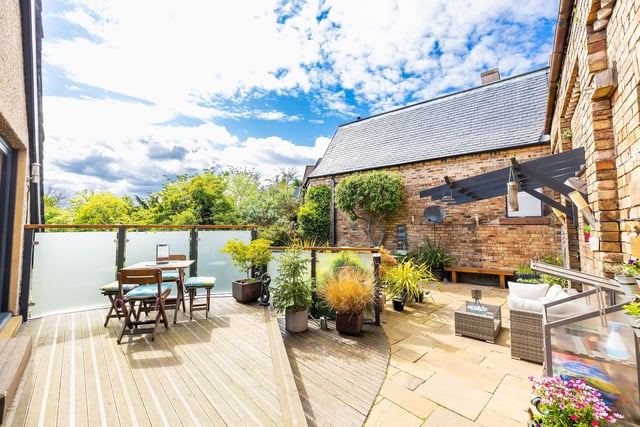 The property has direct access to a private terrace with ambient lighting, decking, patio and pergola offering an open outlook. Further garden ground is located to the side of the property.