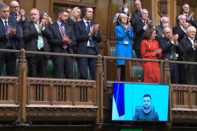 A video grab from footage broadcast by the UK Parliament's Parliamentary Recording Unit (PRU) shows MPs giving a standing ovation to Ukraine's President Volodymyr Zelensky after he speaks to them by live video-link in the House of Commons. Picture: AFP via Getty Images