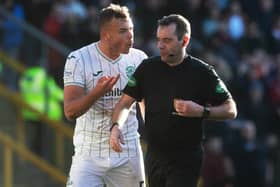 Hibs defender Ryan Porteous argues with referee Alan Muir after his sending-off against Aberdeen