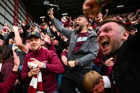 Hearts fans celebrate their team's second goal  (Photo by ANDY BUCHANAN / AFP via Getty Images)