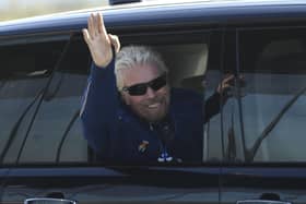 Richard Branson waves as he arrives at a base in Las Cruces, New Mexico