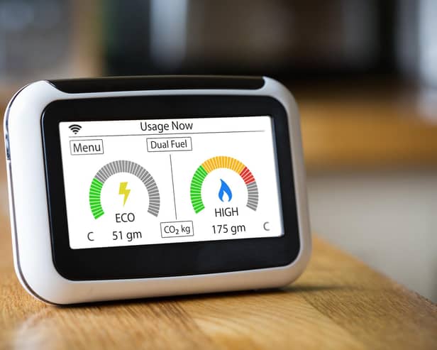 Domestic Energy Smart Meter on a Kitchen Worktop Displaying Electric and Gas Carbon Emissions in Real Time.