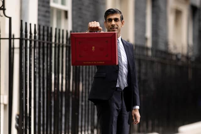 Chancellor Rishi Sunak holds the budget box as he departs 11 Downing Street (Picture: Dan Kitwood/Getty Images)