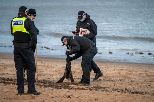 A black cardigan appears to be found as Police Scotland officers scour the beach at Portobello  (Photo: Andrew O'Brien).