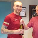 Man of the match Dylan Tait receives his award from sponsor Jim Hughes