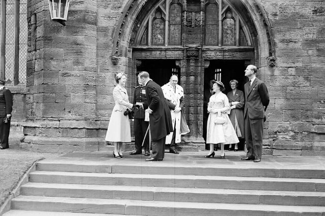 The Queen outside St Michael's Church, Linlithgow saying goodbye to the Rev C N Rutherfurd.  Colonel Cadell, Provost Thomas, the Duke of Edinburgh and Mrs Rutherfurd look on.