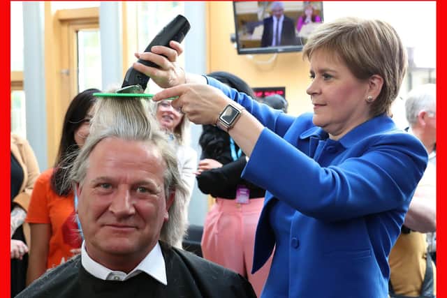 Nicola Sturgeon cuts the hair of David Torrance MSP for charity in September last year (Picture: Andrew Milligan/PA Wire)