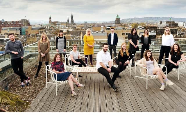 Members of the Muckle Media team pictured against an Edinburgh backdrop.