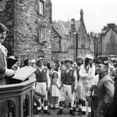 Basil Skinner can be seen here addressing the members of the Dean Village Association during a historical pageant and fair. Year: 1975.