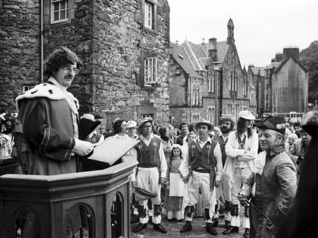 Basil Skinner can be seen here addressing the members of the Dean Village Association during a historical pageant and fair. Year: 1975.