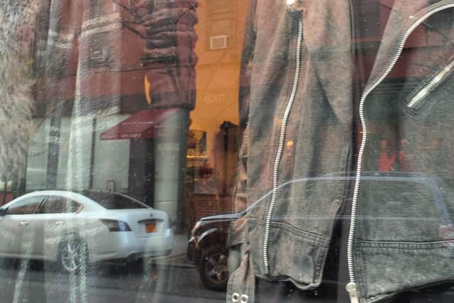 Shop window reflecting a New York street, from Manikins by Mark Jones.