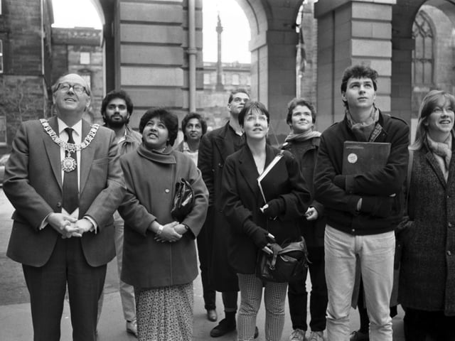 Lord Provost John Mackay and political and student representatives look up as the African National Congress flag is raised over Edinburgh City Chambers in December 1985.