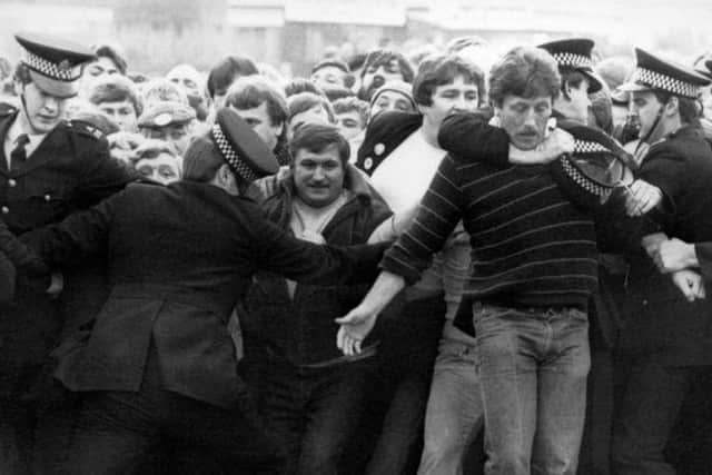 Police restrain picketers outside a pit during the miners' strike in the 1980s.