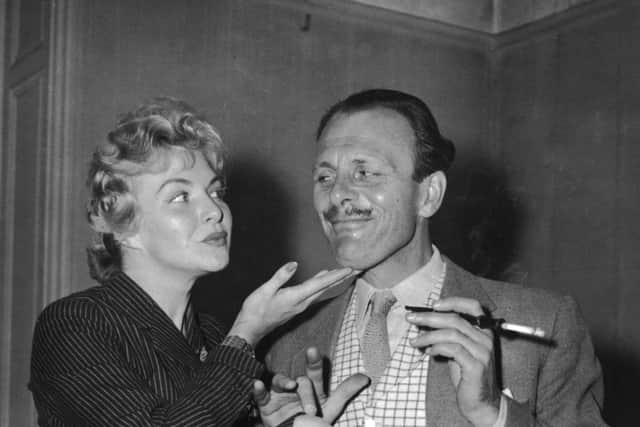 Terry-Thomas flirts with French actress Line Renaud while filming for TV Around Town in 1955. Is the age of the office romance now over? (Picture: Edward Miller/Keystone/Getty Images)