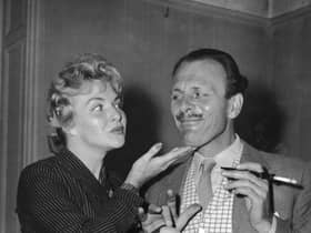 Terry-Thomas flirts with French actress Line Renaud while filming for TV Around Town in 1955. Is the age of the office romance now over? (Picture: Edward Miller/Keystone/Getty Images)