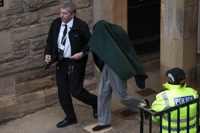 Andrew Miller, who has now pled guilty to abducting and sexually assaulting a girl, was taken from Selkirk Sheriff covered by a blanket in February. Picture: Jeff J Mitchell/Getty Images