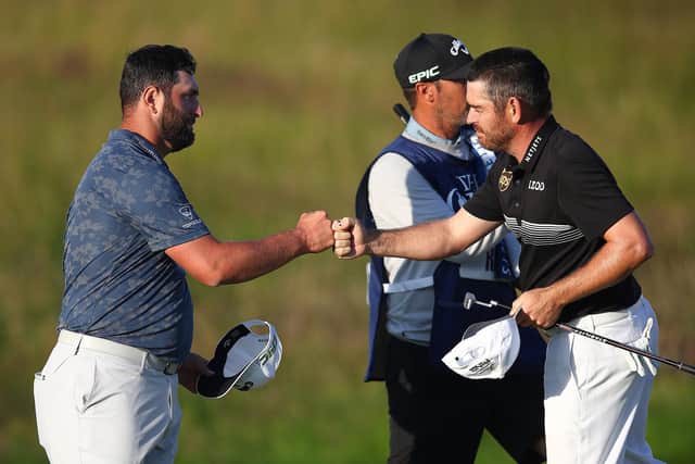 Jon Rahm and Louis Oosthuizen bump fists on the 18th green. Picture: Christopher Lee/Getty Images