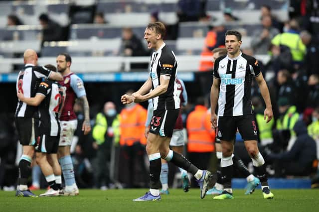 NEWCASTLE UPON TYNE, ENGLAND - FEBRUARY 13: Dan Burn of Newcastle United celebrates their sides victory after the Premier League match between Newcastle United and Aston Villa at St. James Park on February 13, 2022 in Newcastle upon Tyne, England. (Photo by George Wood/Getty Images)