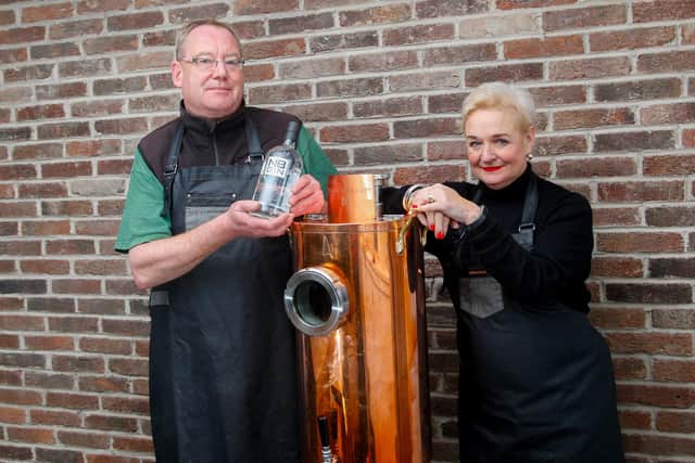 NB Distillery's Steve Ross, head of production, and Rhona Hartley, head of corporate sales and retail, with 'Dolly' the dispenser that will be used to refill customers gin bottles in an eco-friendly initiative for the spirit firm