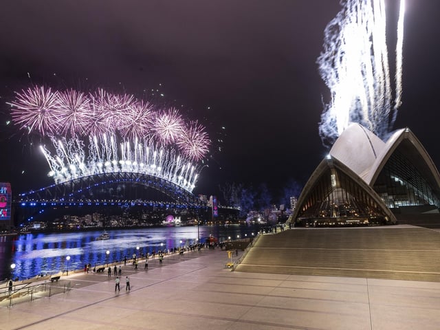 The Sydney Harbour fireworks display is seen over a near-empty Sydney Opera House forecourt during New Year's Eve celebrations on January 01, 2021 in Sydney, Australia. Amidst a new outbreak of COVID-19 in Sydney, the normally 12-minute long midnight pyrotechnic display has been shortened to seven minutes. New COVID-19 restrictions are also in effect across NSW with household gatherings limited to five guests in greater Sydney, Wollongong, the Central Coast and Blue Mountains. Sydney's Northern Beaches remain in lockdown as health authorities work to contain current coronavirus cluster outbreaks in the community.