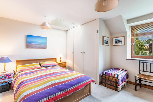 The property's second bedroom, situated on the first floor, is tastefully decorated with extensive fitted storage.