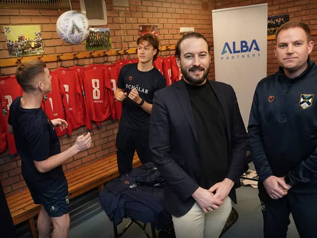 Richard Jacobs  of ALBA with Edinburgh University Association Football Club manager, Sean McAuley, and players immediately before the Albion Rovers match at Peffermill on 9 December. Photo by Stewart Atwood.