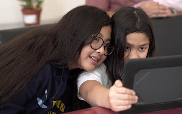 Many children are fascinated by modern technology (Picture: STR/AFP via Getty Images)