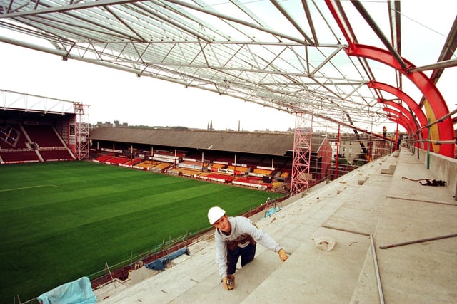 Sealant applicator David Graham [23] at work on Hearts' new stand at the 'Gorgie Road end', in the summer of 1997. Traditionally the away end for many years until this stand was built, with away supporters now occupying the 'school end'.