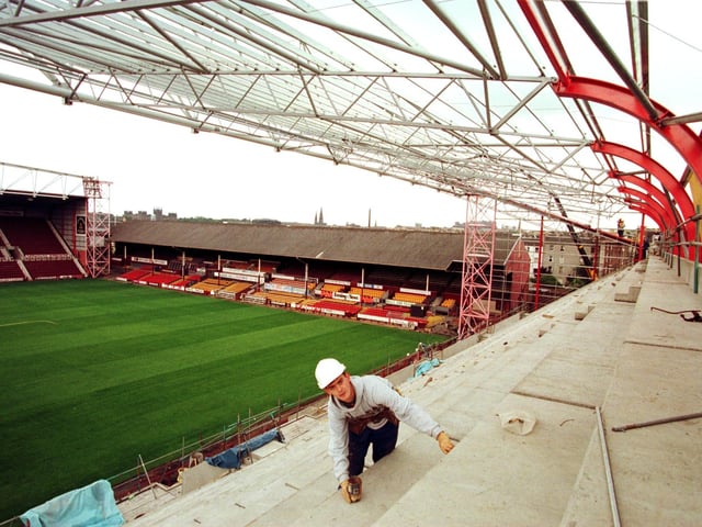 Sealant applicator David Graham [23] at work on Hearts' new stand at the 'Gorgie Road end', in the summer of 1997. Traditionally the away end for many years until this stand was built, with away supporters now occupying the 'school end'.