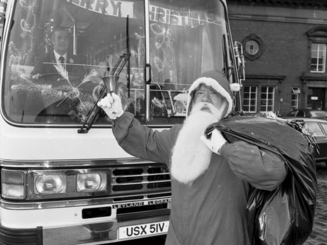 Lothian Region Transport bus driver Willie Combe dressed as Santa to deliver presents to children's homes in the area in December 1980.
