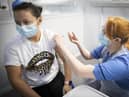 Nurse Eleanor Pinkerton administers a coronavirus vaccine to one of the health and social care staff at the NHS Louisa Jordan Hospital in Glasgow, as part of a mass vaccination drive by NHS Greater Glasgow and Clyde. Picture date: Saturday January 23, 2021.