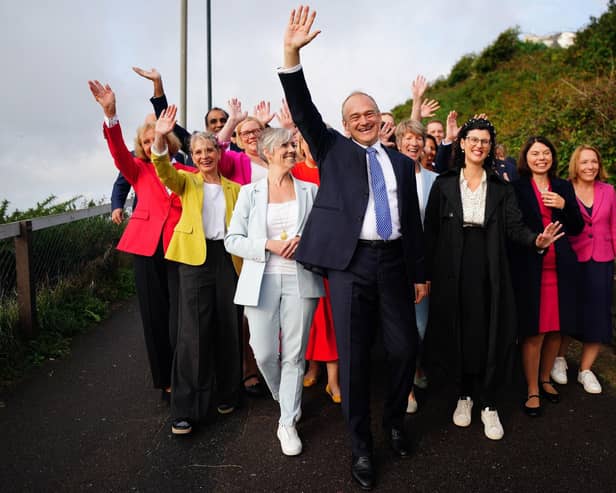 Liberal Democrat leader Ed Davey, centre, arrives with Daisy Cooper, front left, Layla Moran, front right, and parliamentary candidates for the Liberal Democrat conference at the Bournemouth Conference Centre