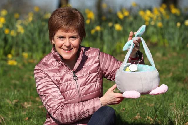 Scotland's First Minister Nicola Sturgeon holds a basket at Ruchill Park in Glasgow.