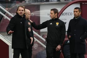 Hearts manager Robbie Neilson and Rangers boss Giovanni Van Bronckhorst both speaking with the fourth official during the match at Tynecastle. Picture: SNS